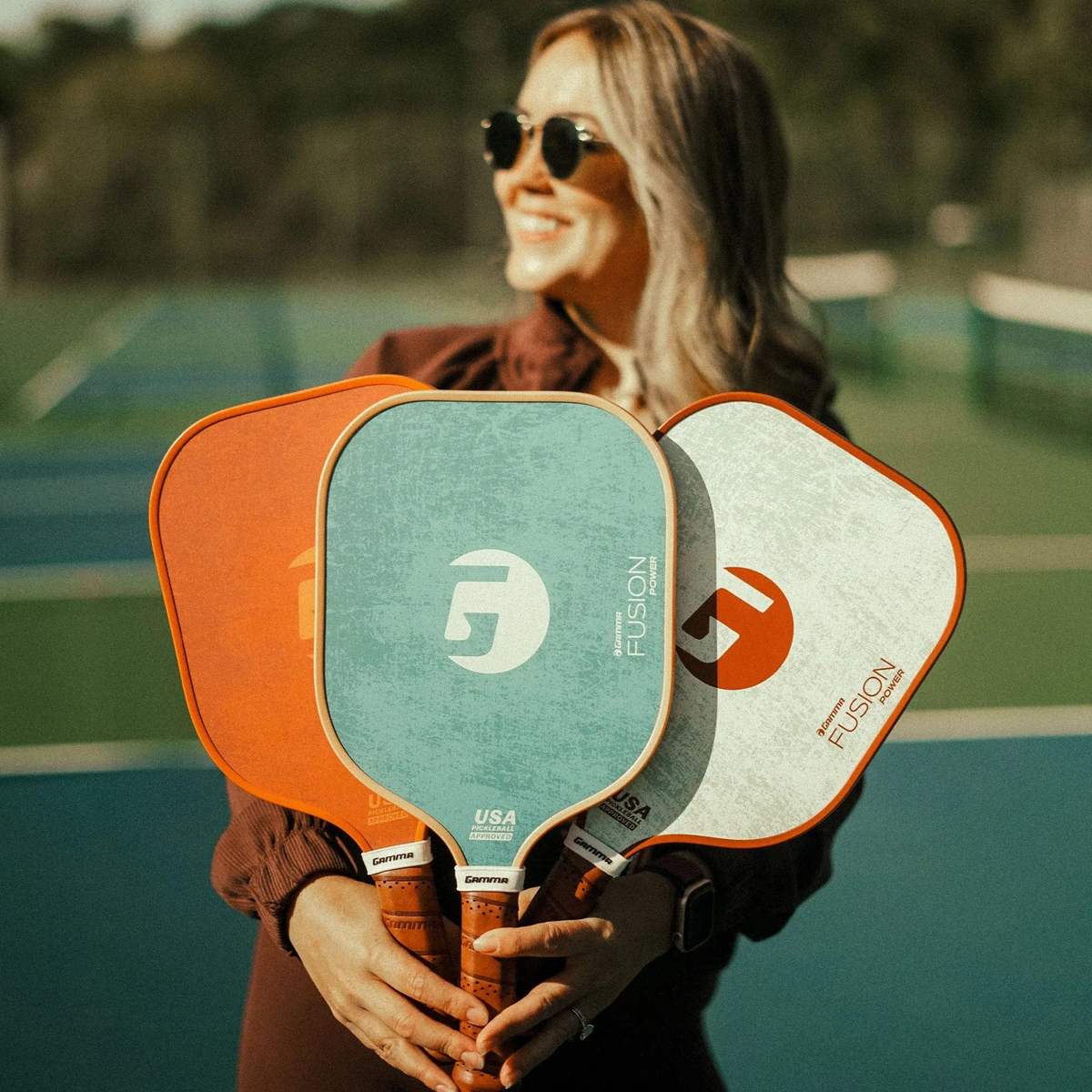 Set of pickleball paddles with wide faces, textured surfaces, and cushioned grip handles designed for power and control.