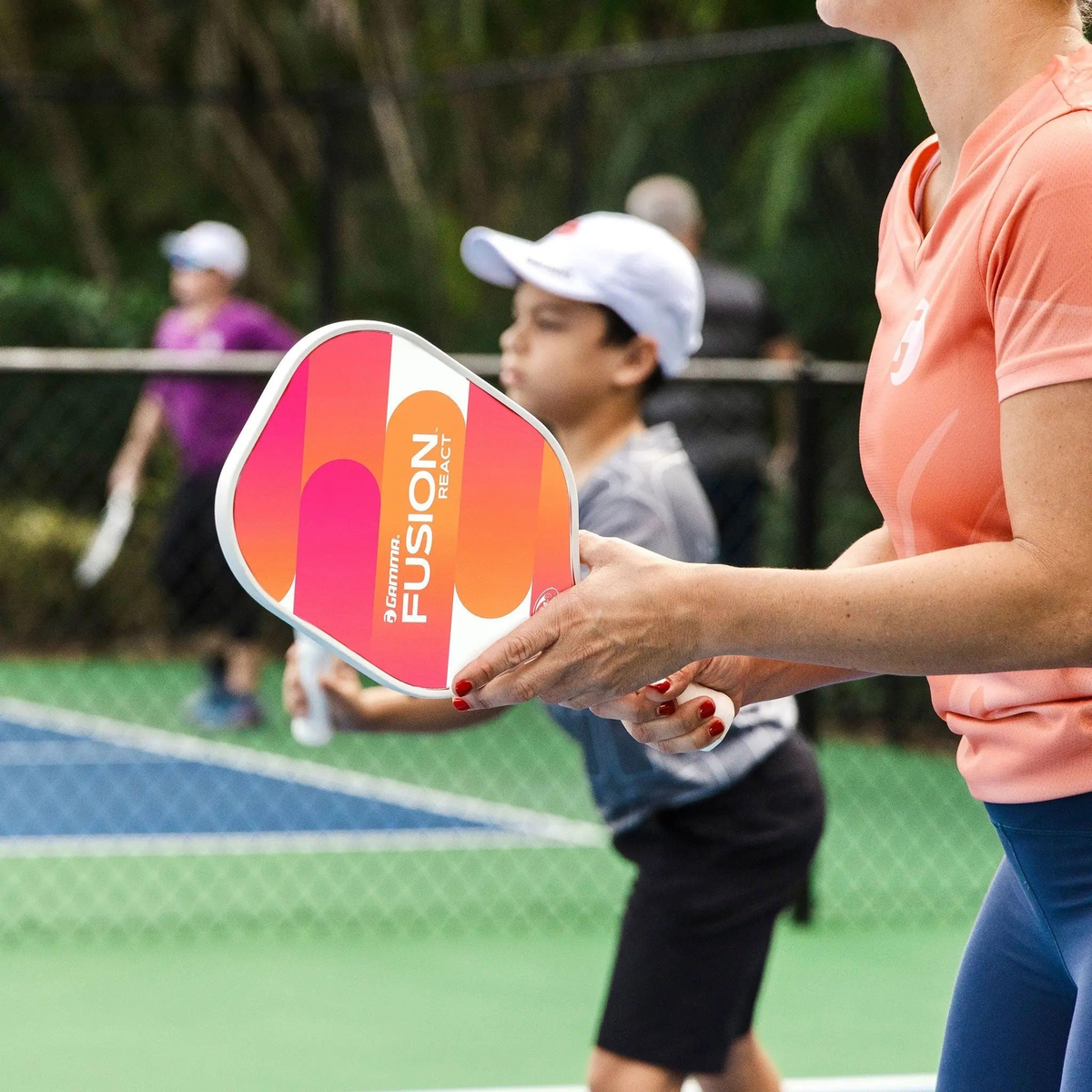 Set of pickleball paddles with wide faces, smooth graphic designs, and cushioned grip handles for responsive control and performance.