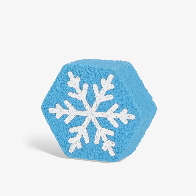 Pickleball paddle cleaning block being used on a paddle surface, designed to remove debris and maintain paddle performance.