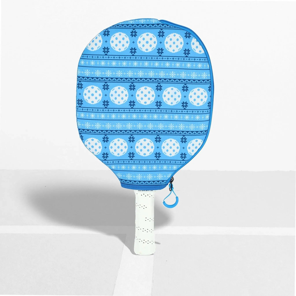 Pickleball paddle cover with a festive patterned design and zipper closure, designed to protect and store a paddle.