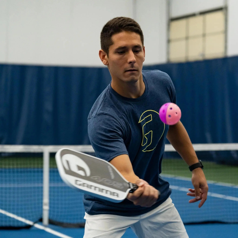 Indoor training pickleball with a two-piece design and evenly spaced holes, built for controlled play and consistent bounce during practice.