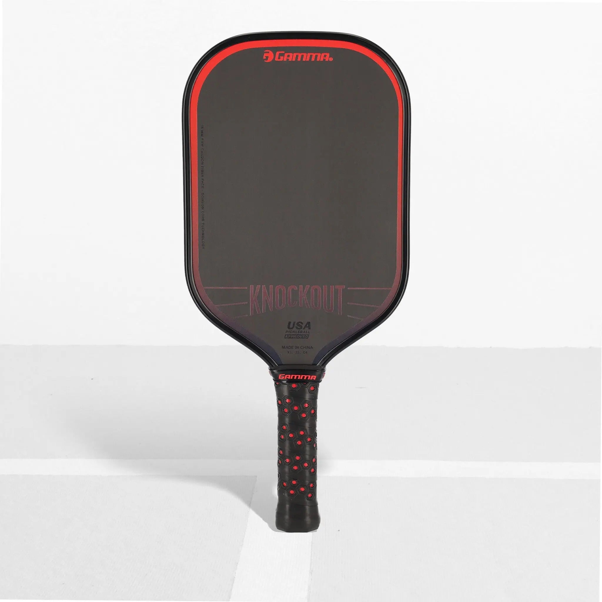 Pickleball paddle with a sleek solid face and cushioned handle, designed for power and control during gameplay.