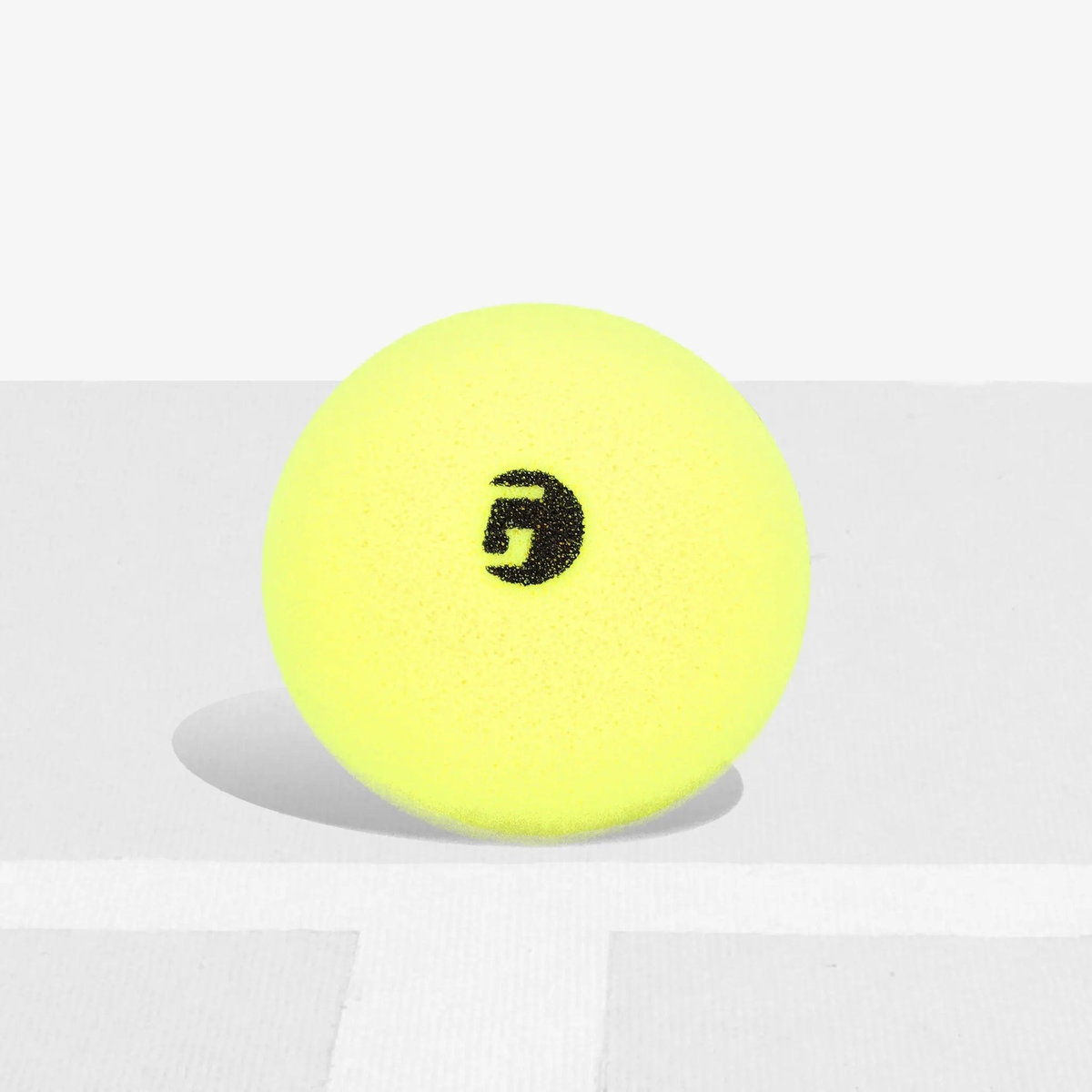 Foam pickleball designed for training or practice, featuring a smooth surface and lightweight construction.