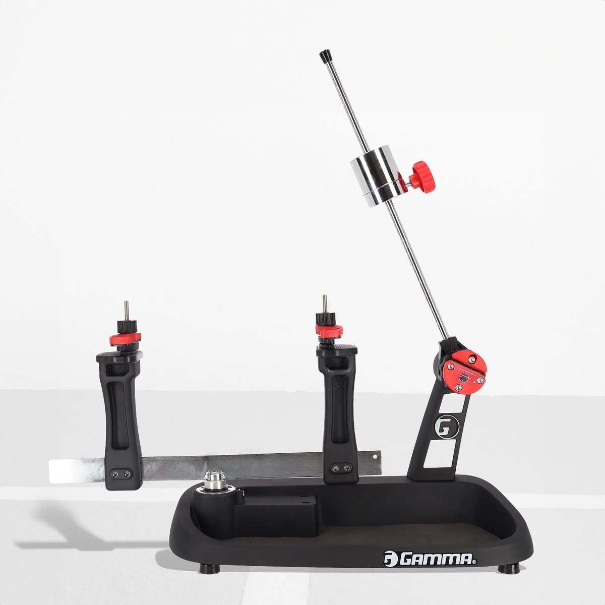 Manual drop weight stringing machine with a base platform, vertical support posts, adjustable tension arm, and mounting clamps for securing racquets during stringing.