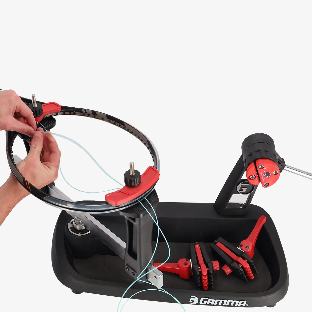 Manual drop weight stringing machine with a base platform, vertical support posts, adjustable tension arm, and mounting clamps for securing racquets during stringing.