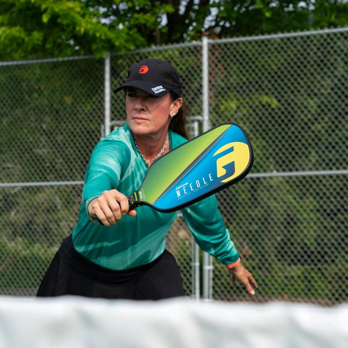 Pickleball paddle with a textured face, elongated shape, and cushioned grip handle designed for control and performance.