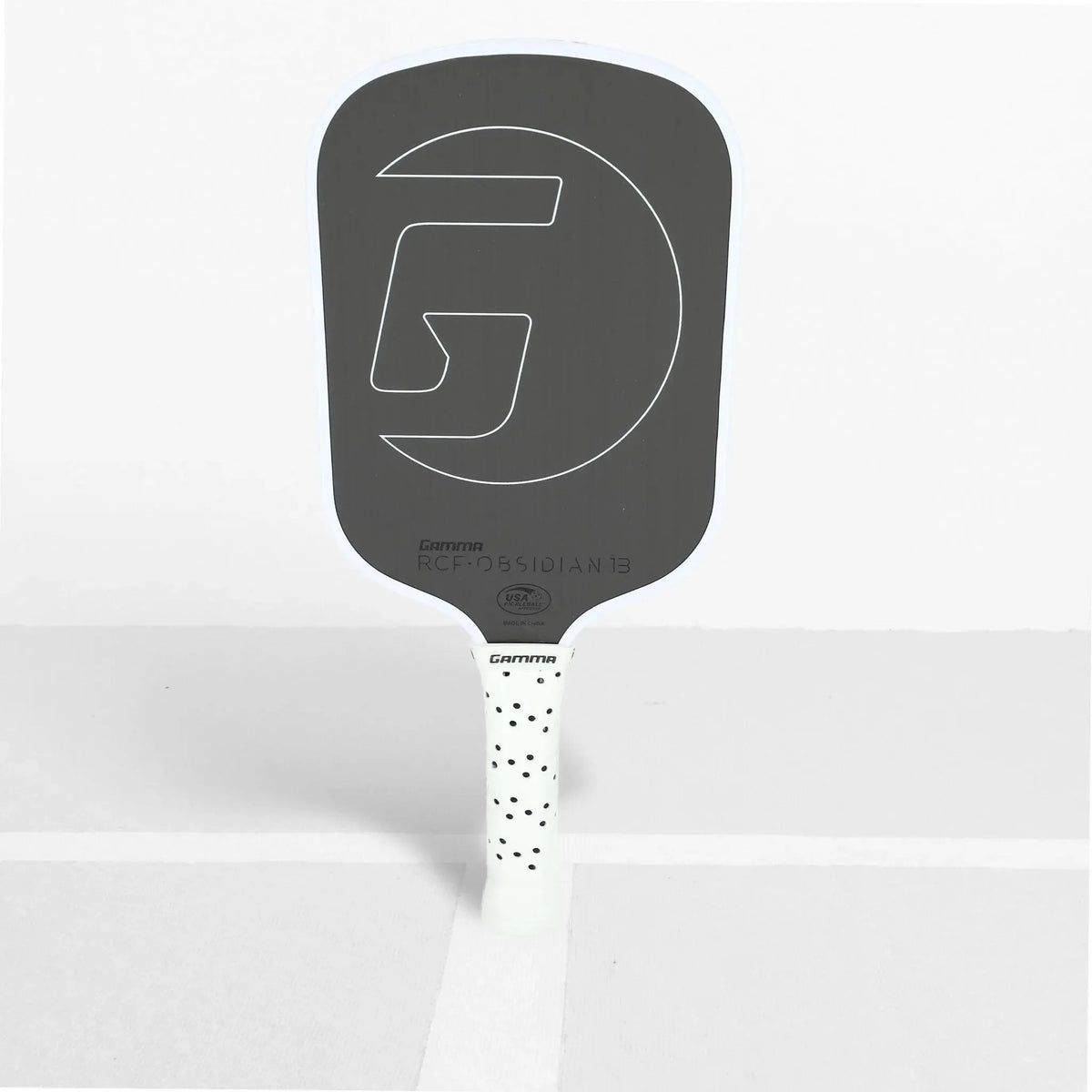Pickleball paddle with a textured face, wide body shape, and cushioned grip handle designed for control and performance.