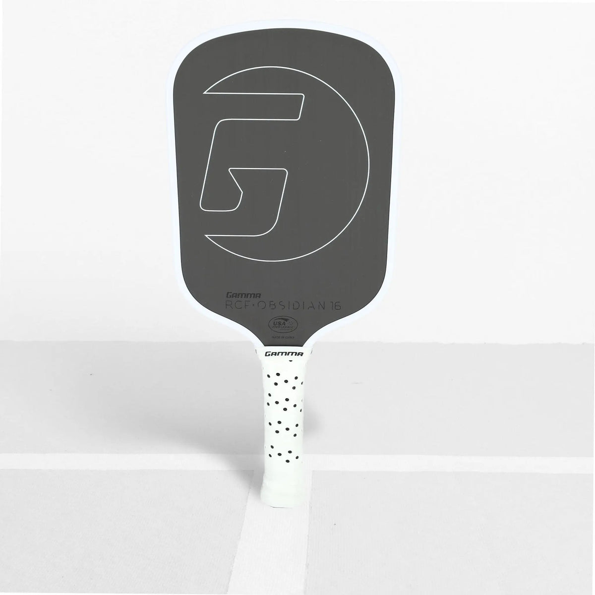 Pickleball paddle with a textured face, wide body shape, and cushioned grip handle designed for control and performance.