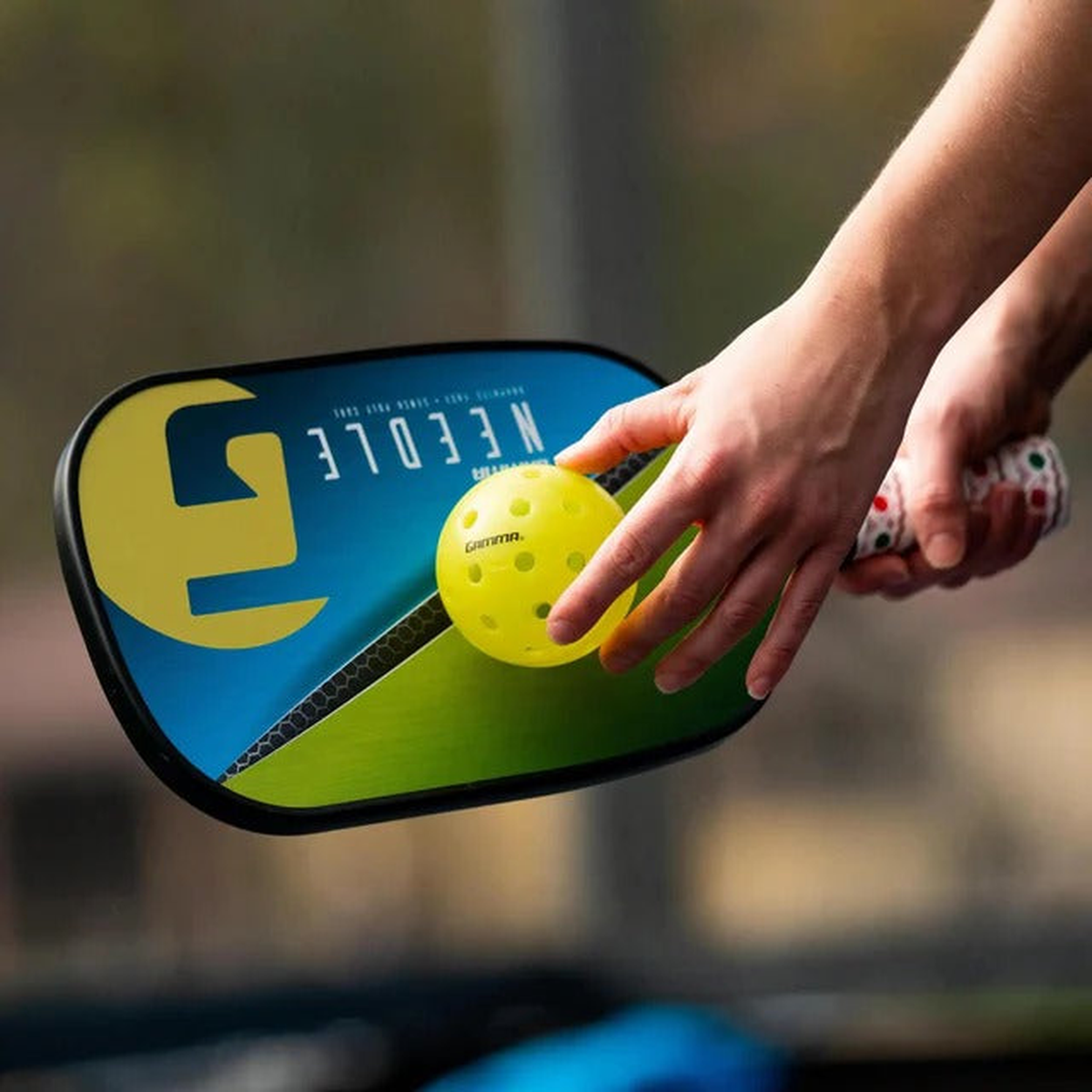 Outdoor pickleball with durable construction and precision-drilled holes, designed for consistent flight and performance in outdoor conditions.