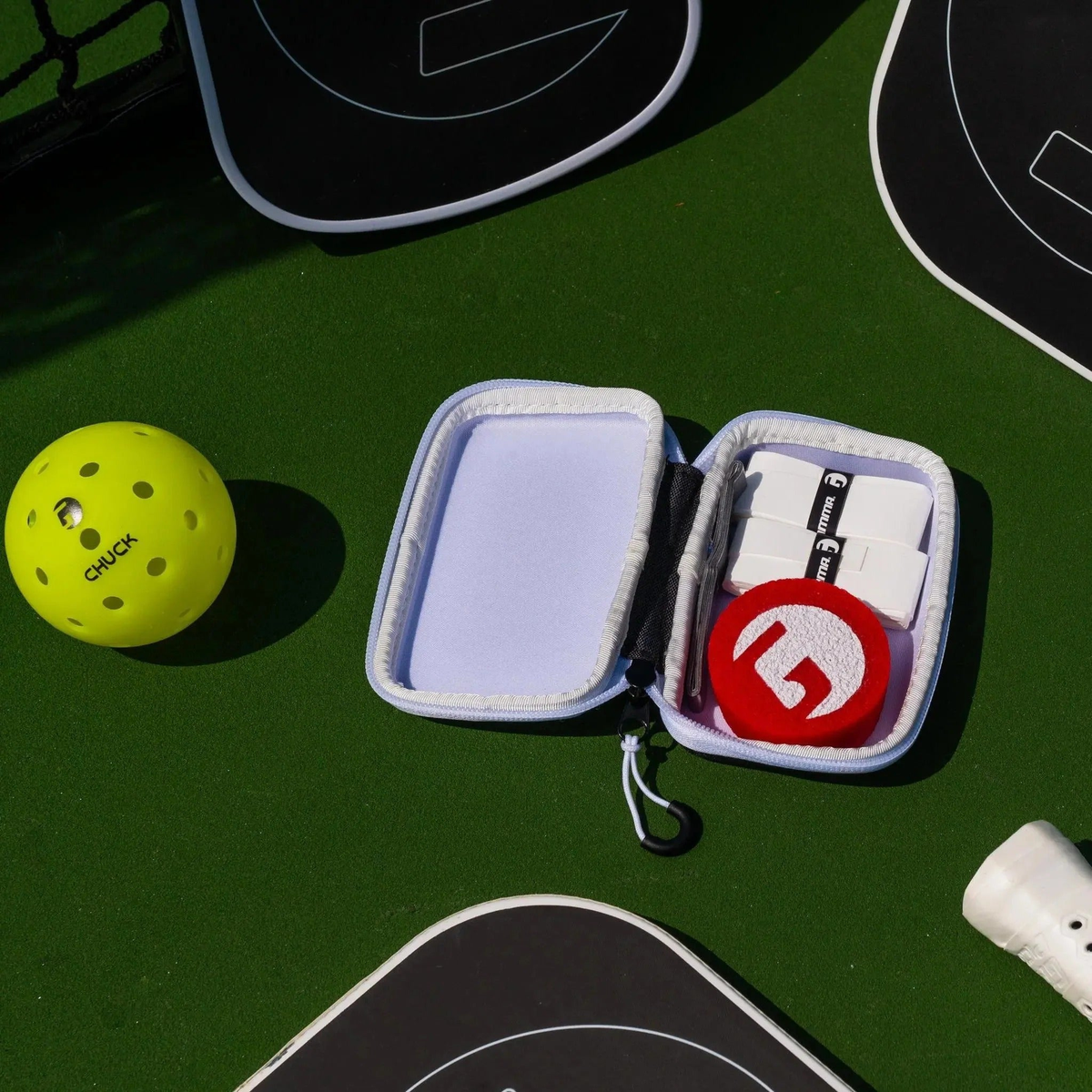 Compact zippered accessory case designed for storing pickleball gear and small essentials.