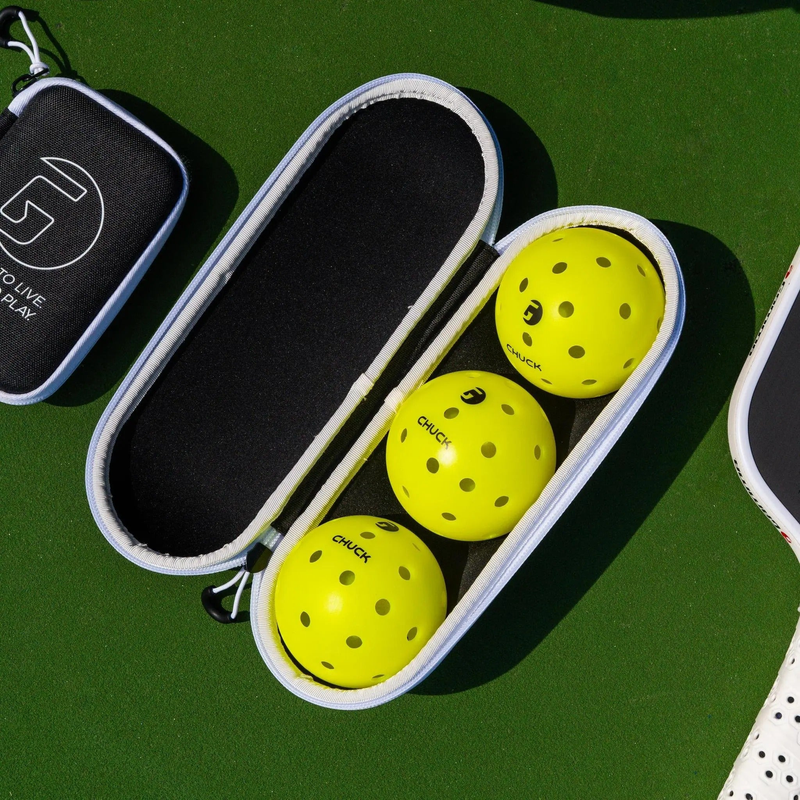 Zippered pickleball ball case with clip attachment, designed for storing and carrying pickleballs.