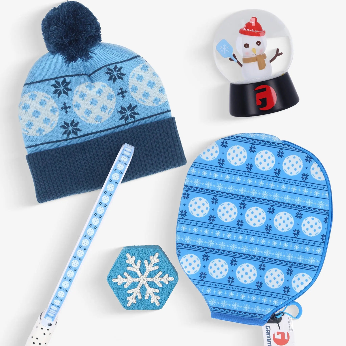 Pickleball gift bundle featuring paddles, paddle cover, winter hat, novelty dampener, and decorative snow globe accessory.