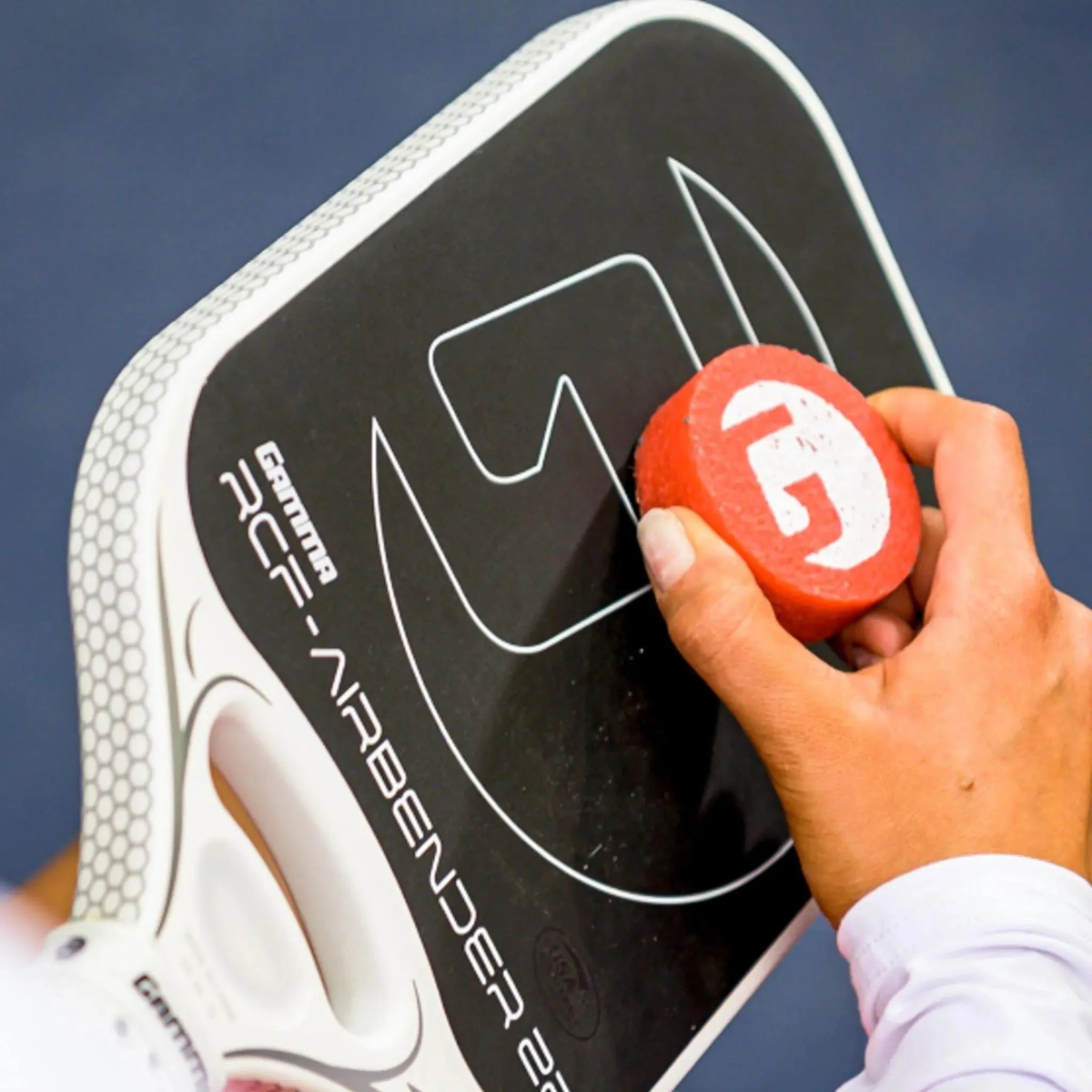 Pickleball paddle cleaning block in retail packaging designed to remove debris and restore paddle surface texture.