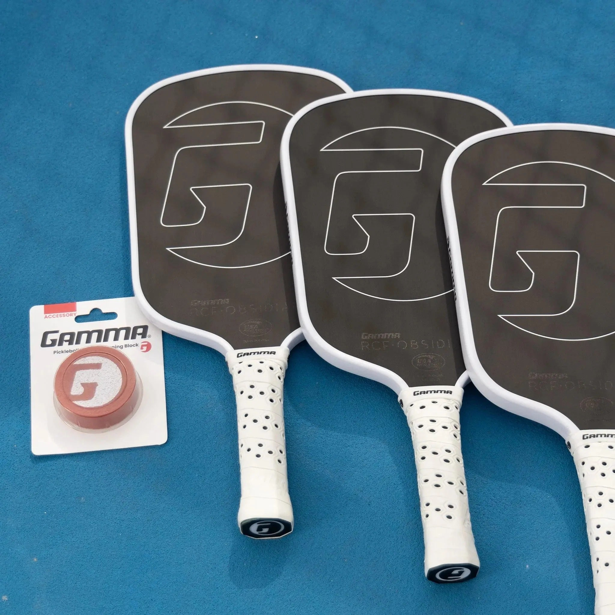Pickleball paddle cleaning block in retail packaging designed to remove debris and restore paddle surface texture.