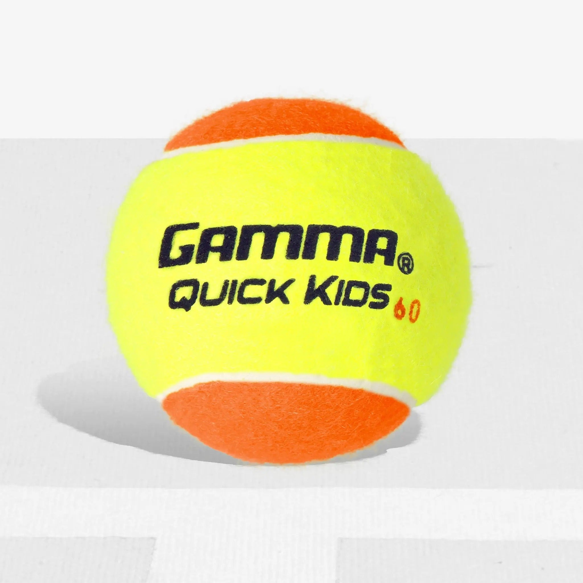 Youth training tennis ball designed for developing players, featuring a lower compression for slower bounce and improved control during practice.