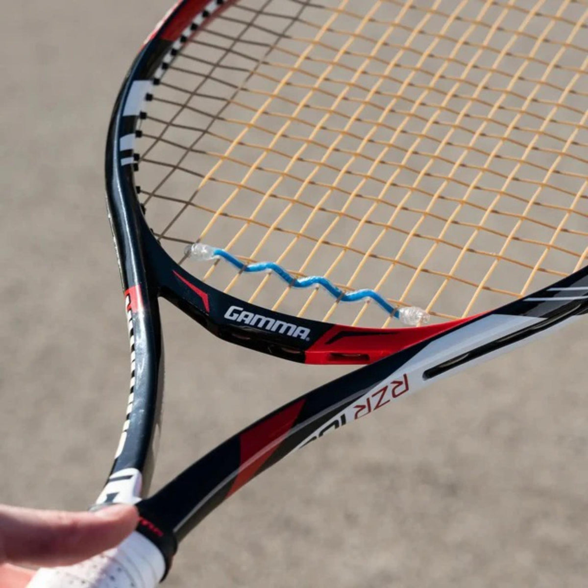 Display box of tennis string dampeners designed to reduce vibration and improve comfort, shown in a multi-pack assortment.