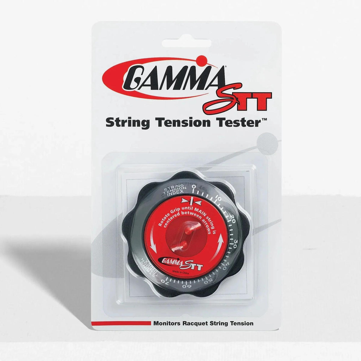 Tennis string tension tester device with a dial gauge, designed to measure and monitor racquet string tension, packaged in retail display.