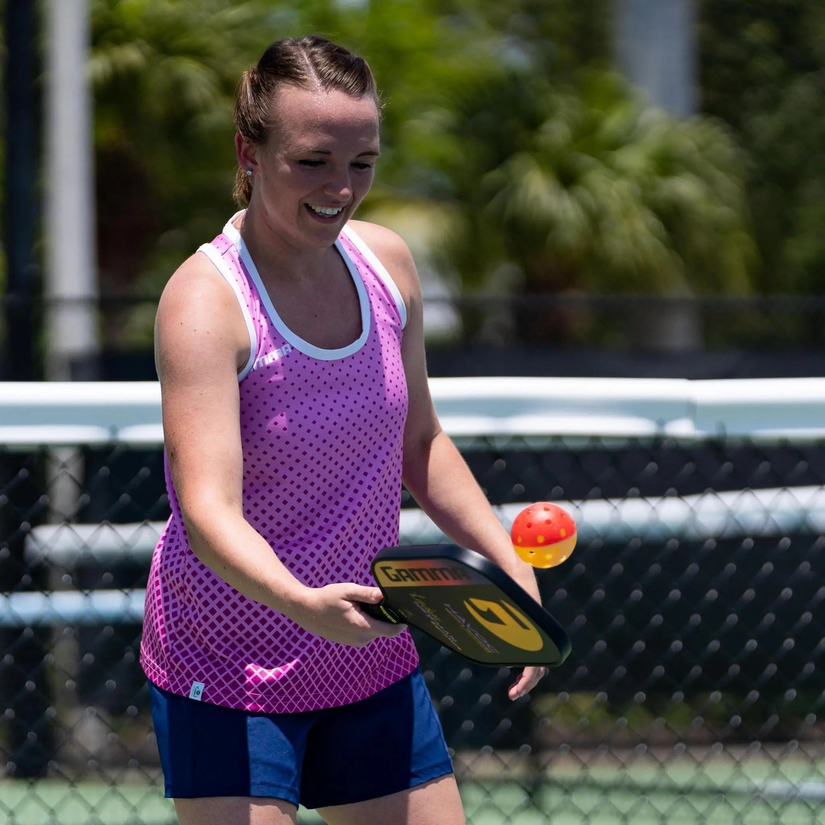 Outdoor pickleball with a two-tone design and evenly spaced holes, designed for training and practice play.