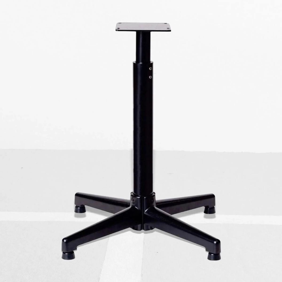 Adjustable floor stand for a stringing machine with a stable multi-leg base and mounting platform on top.