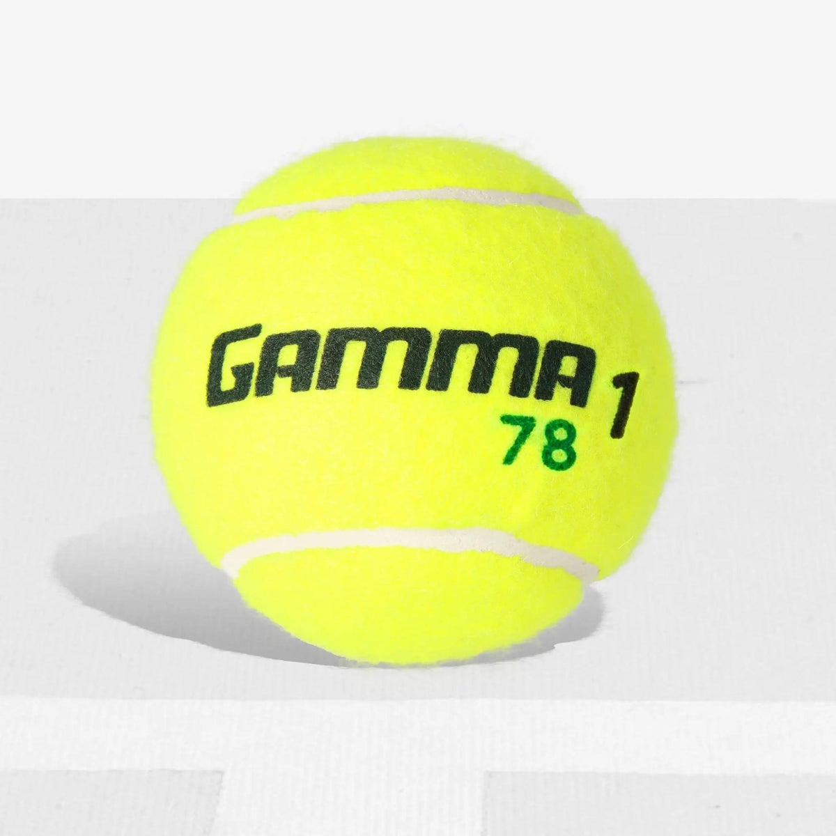 Tennis ball with a durable felt surface and printed branding, designed for controlled play and training.
