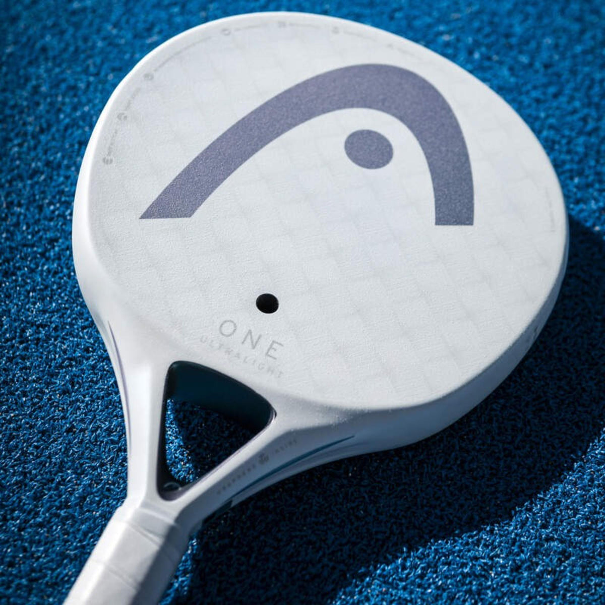Head ONE Ultralight padel racket in white with teal logo, front view on white background.