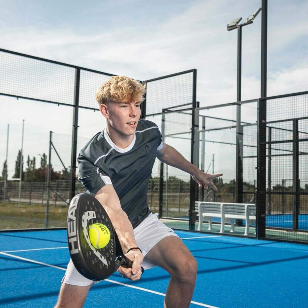 Male athlete hitting padel ball with HEAD Speed Pro racket