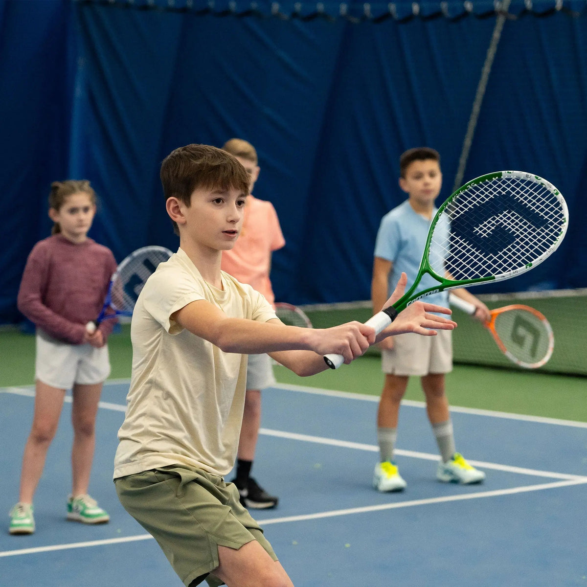 Junior tennis racquet designed for young players, featuring a lightweight frame and smaller grip for easier handling and skill development.