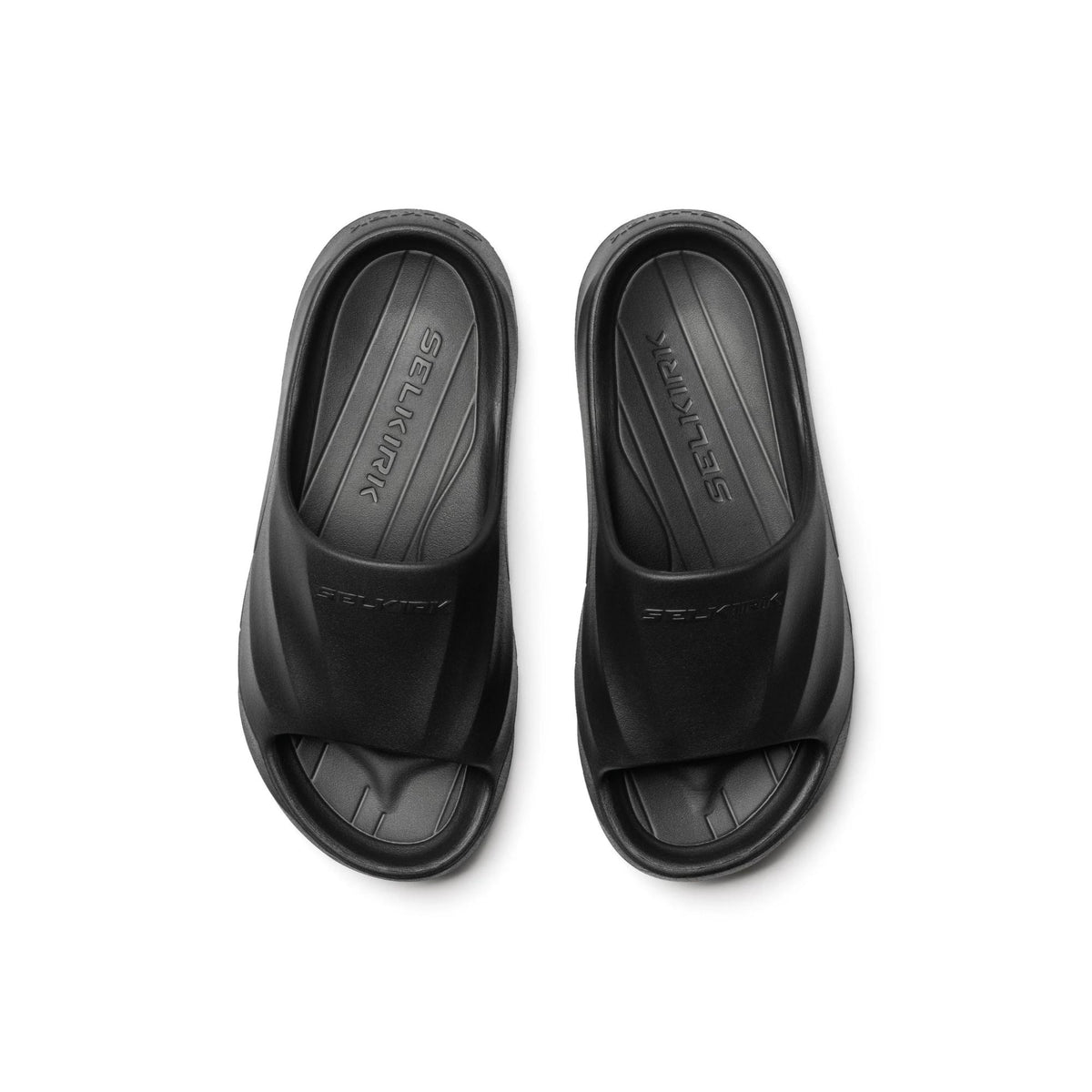 Selkirk Sport Podium pickleball slide sandals with a cushioned footbed, open-toe design, and wide strap featuring embossed branding, shown as a pair.