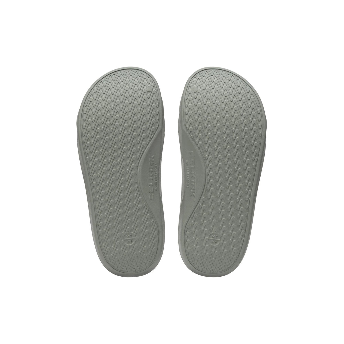 Selkirk Sport Podium pickleball slide sandals with a cushioned footbed, open-toe design, and wide strap featuring embossed branding, shown as a pair.