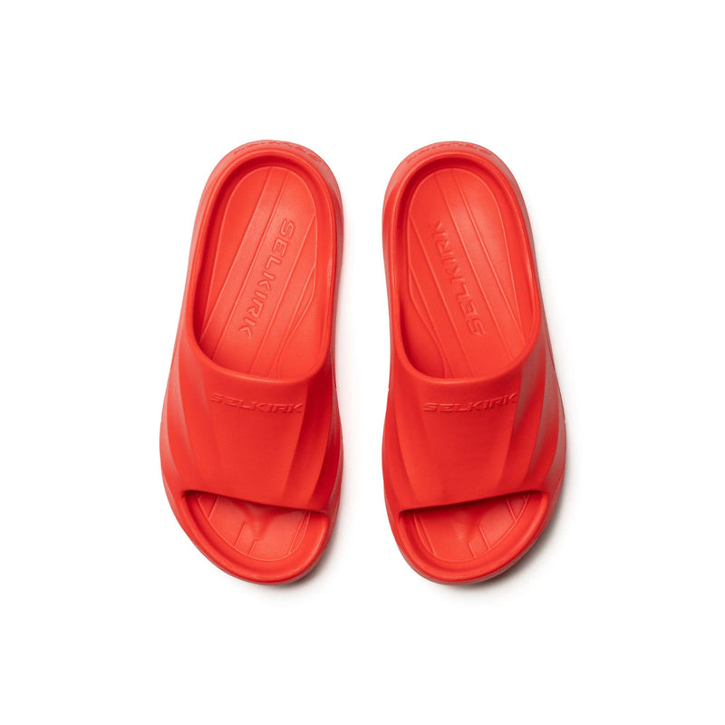 Selkirk Sport Podium pickleball slide sandals with a cushioned footbed, open-toe design, and wide strap featuring embossed branding, shown as a pair.