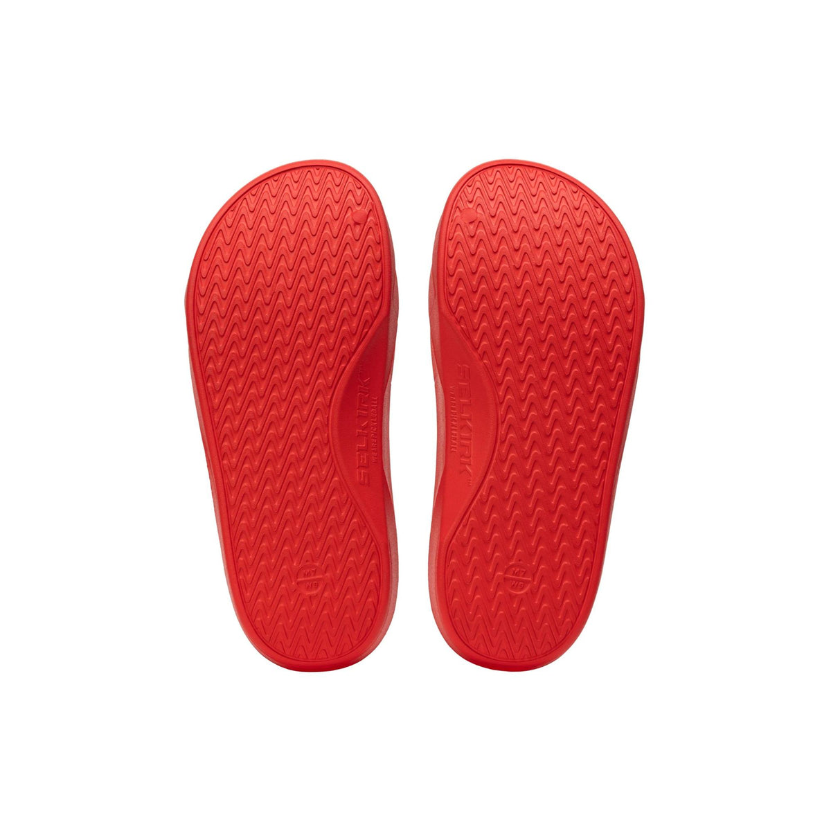 Selkirk Sport Podium pickleball slide sandals with a cushioned footbed, open-toe design, and wide strap featuring embossed branding, shown as a pair.