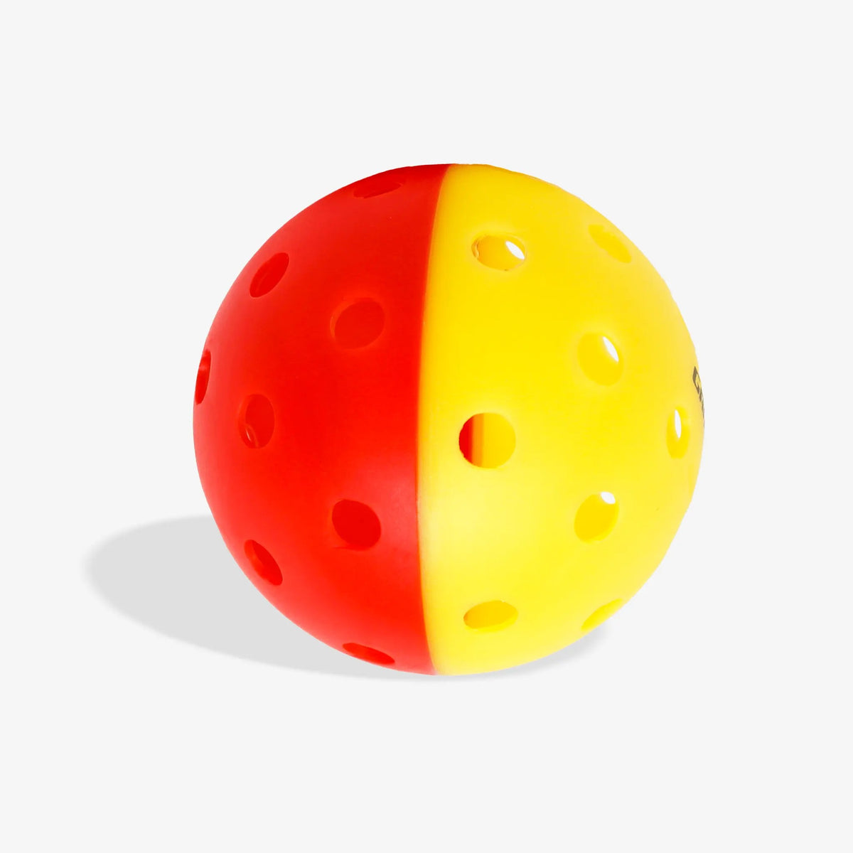 Outdoor pickleball with a two-tone design and evenly spaced holes, designed for training and practice play.